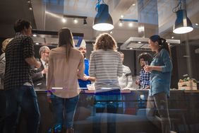 People standing in a professional kitchen celebrating