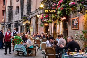 A view of outdoor dining along a street in Madrid