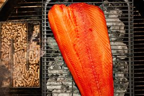 Cold smoking salmon in a charcoal grill.