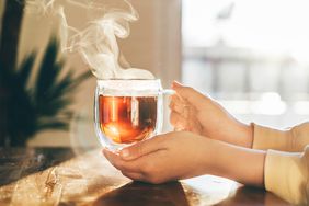 Close-up tea cup on woman's hand