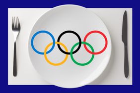 The Olympic rings on a white plate with a fork and knife. 