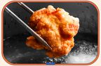 Chopstick holding a piece of deep fried meat