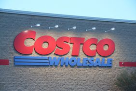 A Costco Wholesale Corporation logo is seen displayed on the exterior of their warehouse.